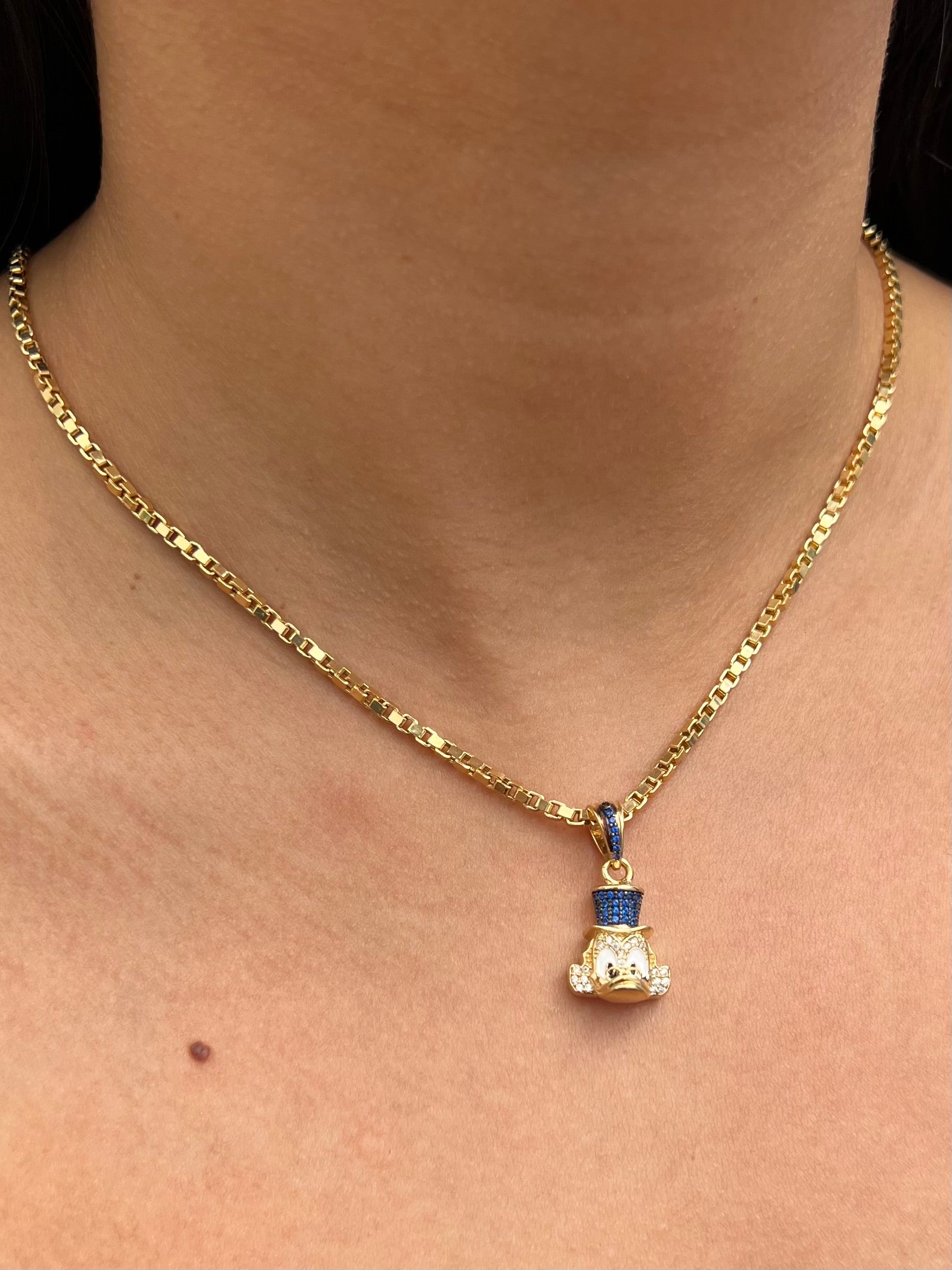 Dije tio rico con swarovski azul y blanco 5.05gr / Largo 2.5cm / Oro Amarillo Nac P