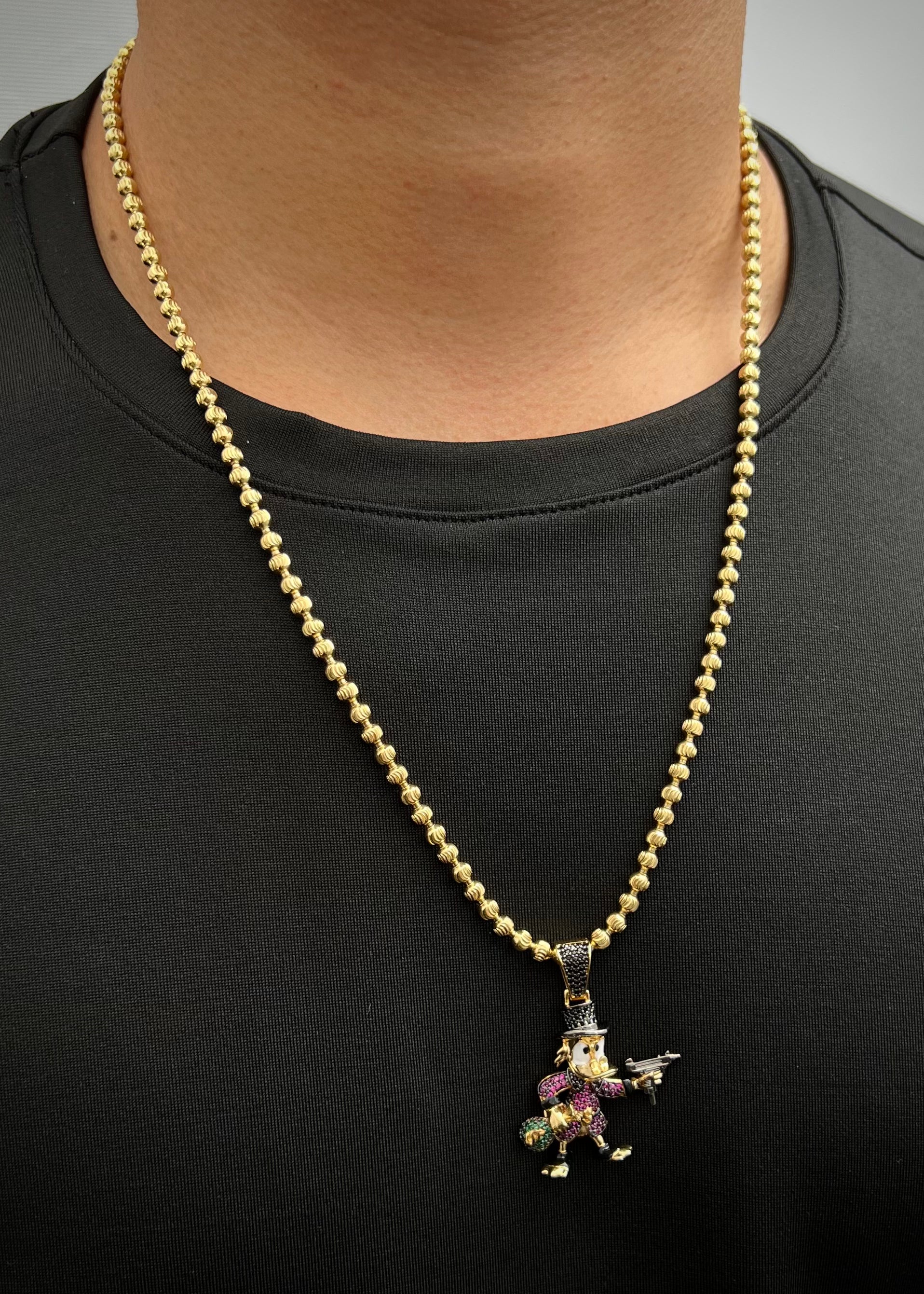 Dije tio rico con swarovski fucsia y negro 10.45gr / Largo 4.3cm / Oro Amarillo Nac B