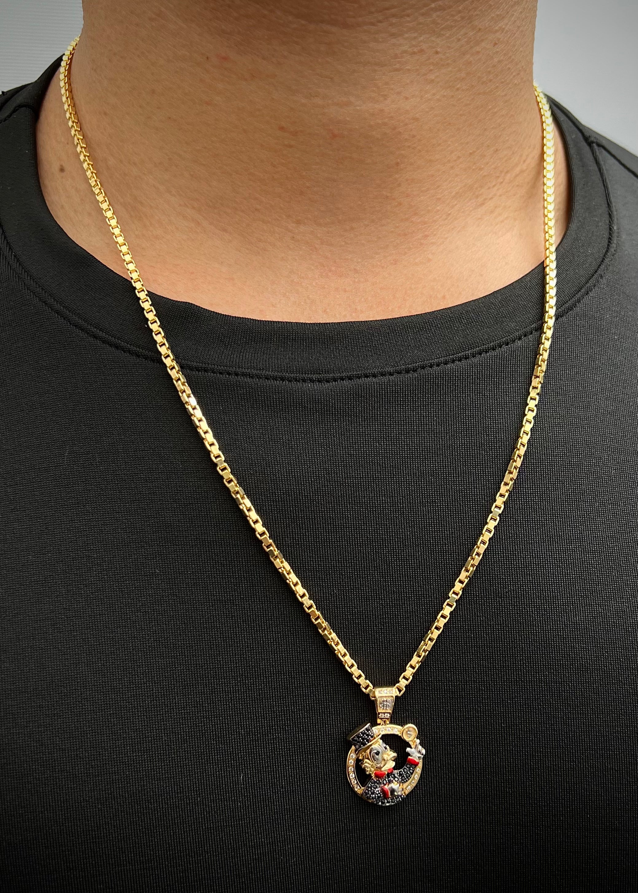 Dije tio rico con swarovski negro y blanco 4.7gr / Largo 2.8cm / Oro Amarillo Nac B