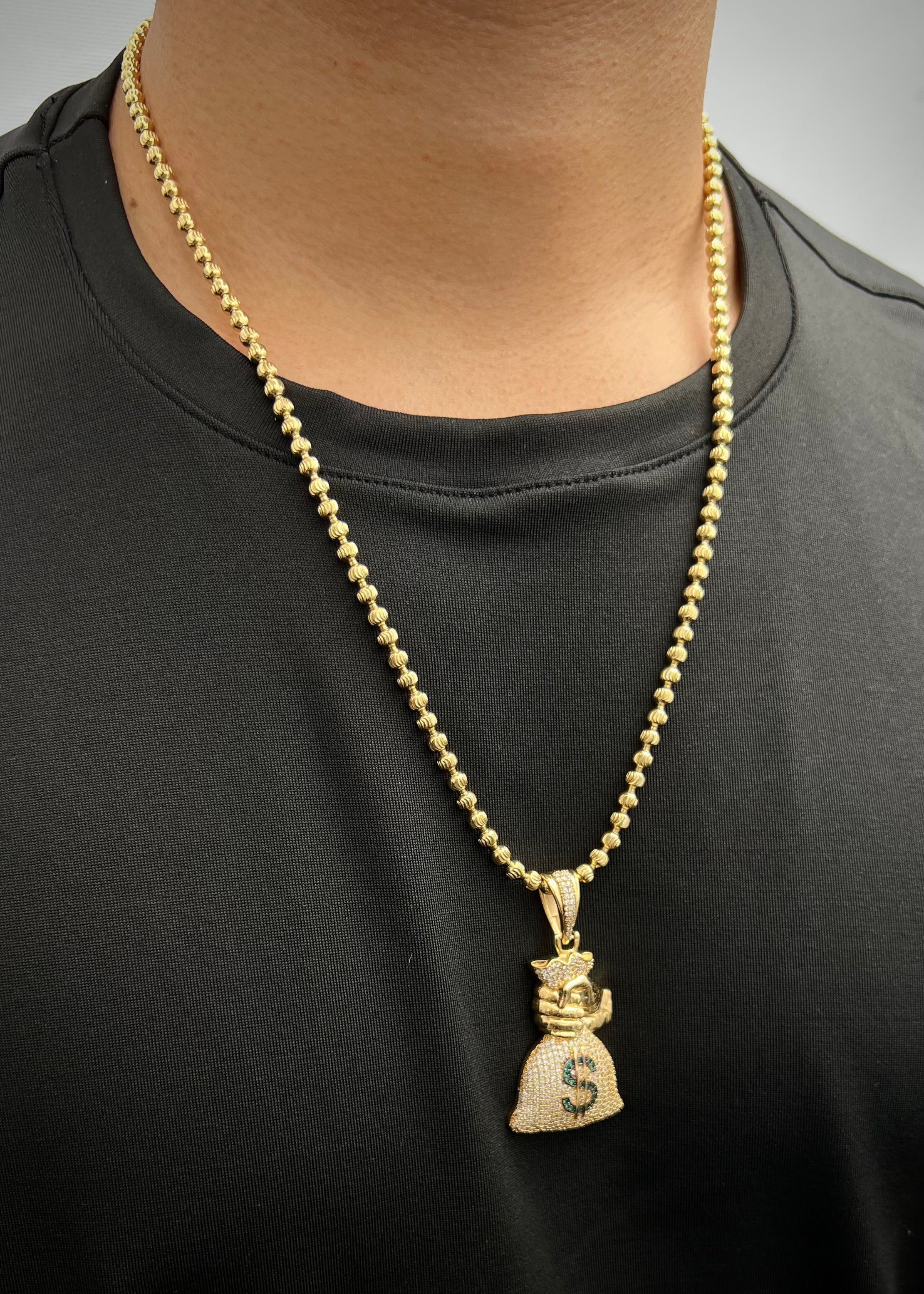 Dije bolsa de dinero con swarovski verde y blanco 11.9gr / Largo 5.3cm / Oro Amarillo Nac B