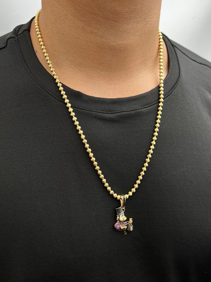 Dije tio rico con swarovski fucsia y negro 6gr / Largo 3.6cm / Oro Amarillo Nac P