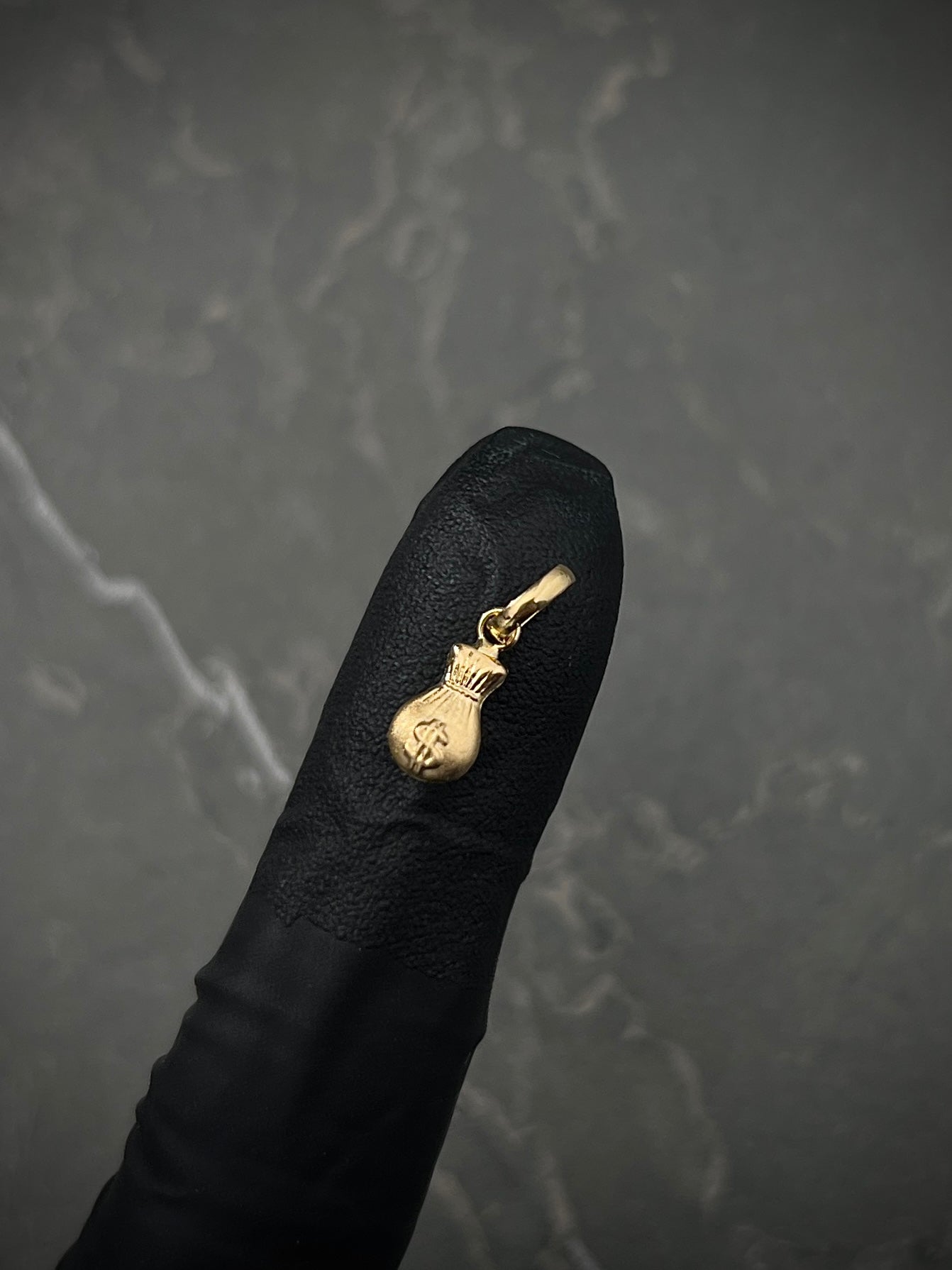 Dije bolsa de dinero 0.3gr / Largo 1.5cm / Oro Amarillo Nac B