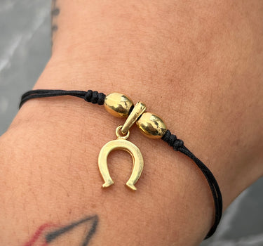 Pulsera en hilo negro con dije de herradura 1.8gr / Oro Amarillo (Joya) M