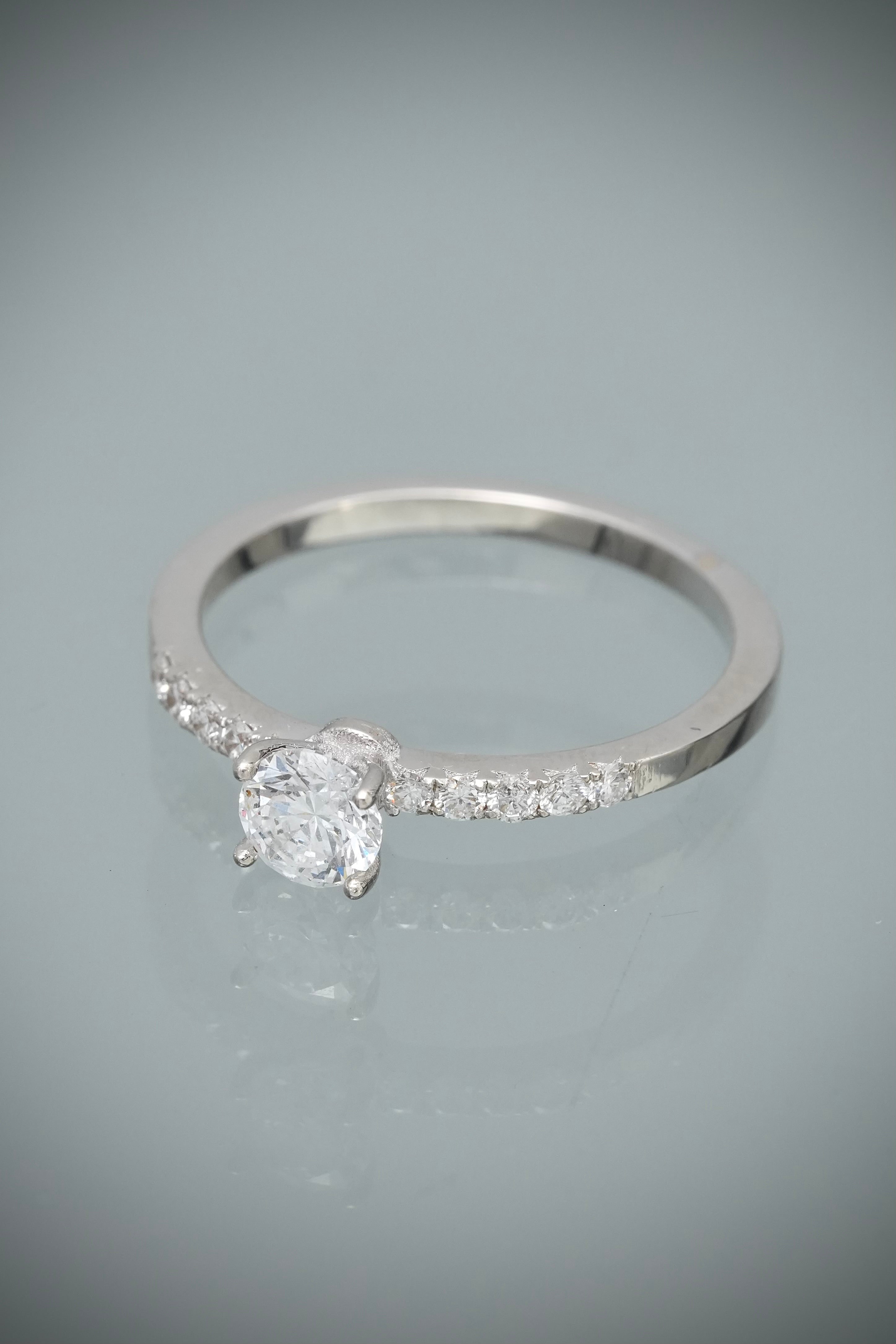 Solitario con 38pts de diamante central y 15pts de diamantes laterales 2.2gr / TALLA 6 1/4 / Oro Blanco (Joya) B