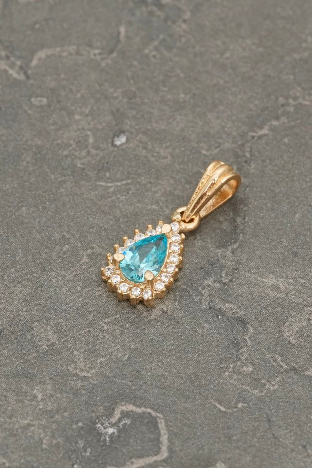 Dije gota con swarovski blanco y azul 1.15gr / Largo 1.7cm — Oro Amarillo
