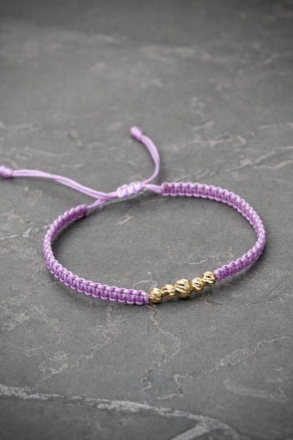 Pulsera en hilo morado con bolas diamantadas 0.45gr / Oro Amarillo (Joya) M