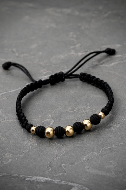 Pulsera en hilo negro con bolas lisas 0.75gr — Oro Amarillo