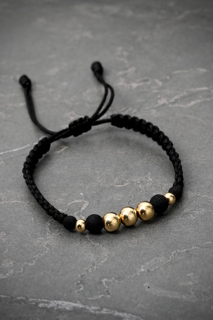 Pulsera hilo negro con bolas lisas. 0.75gr — Oro Amarillo