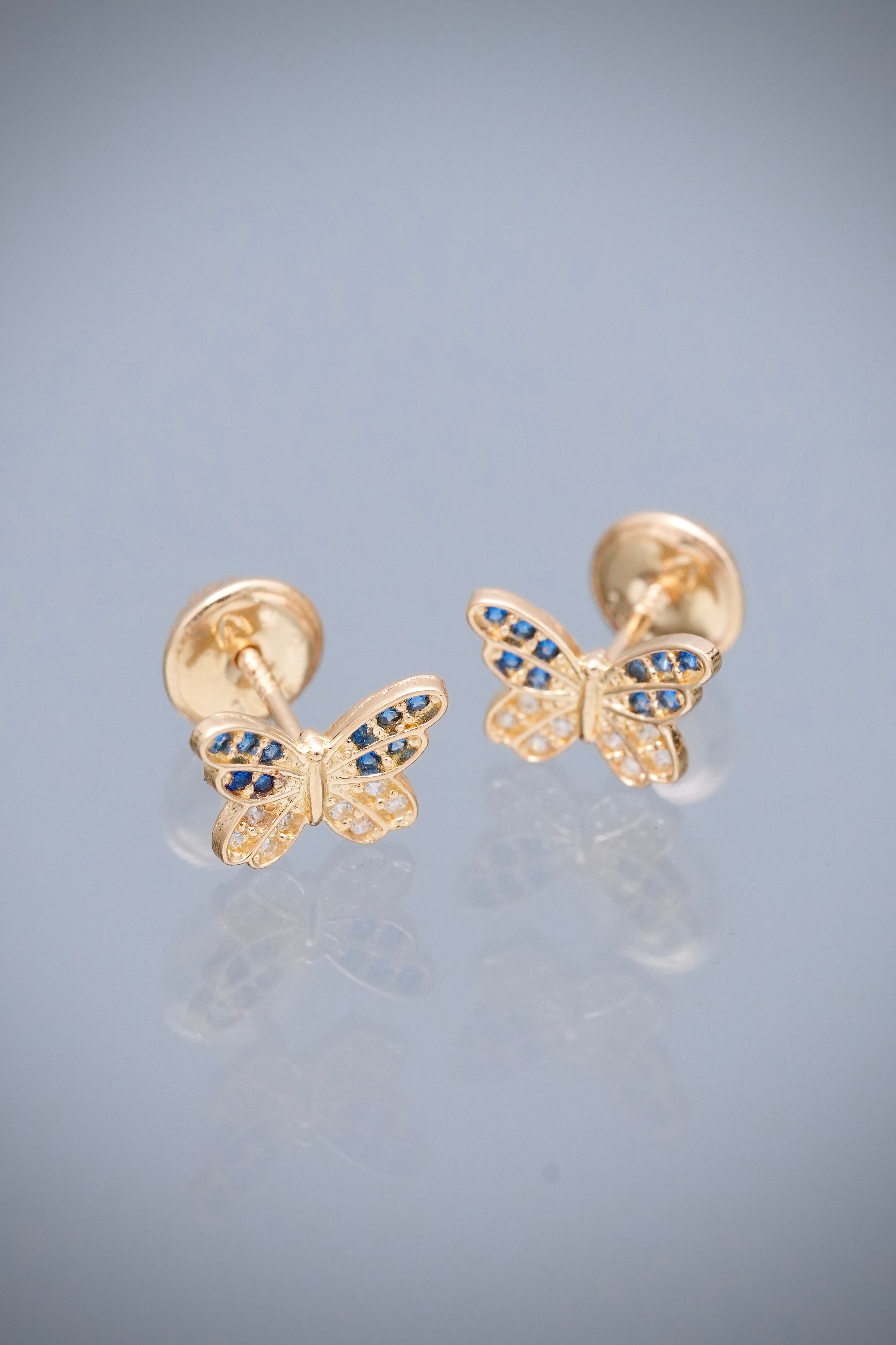 Topos mariposa con swarovski azul y blanco 0.95gr / Largo 0.6cm — Oro Amarillo