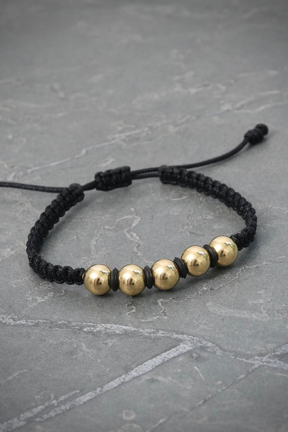 Pulsera en hilo negro con bolas lisas 1.6gr — Oro Amarillo