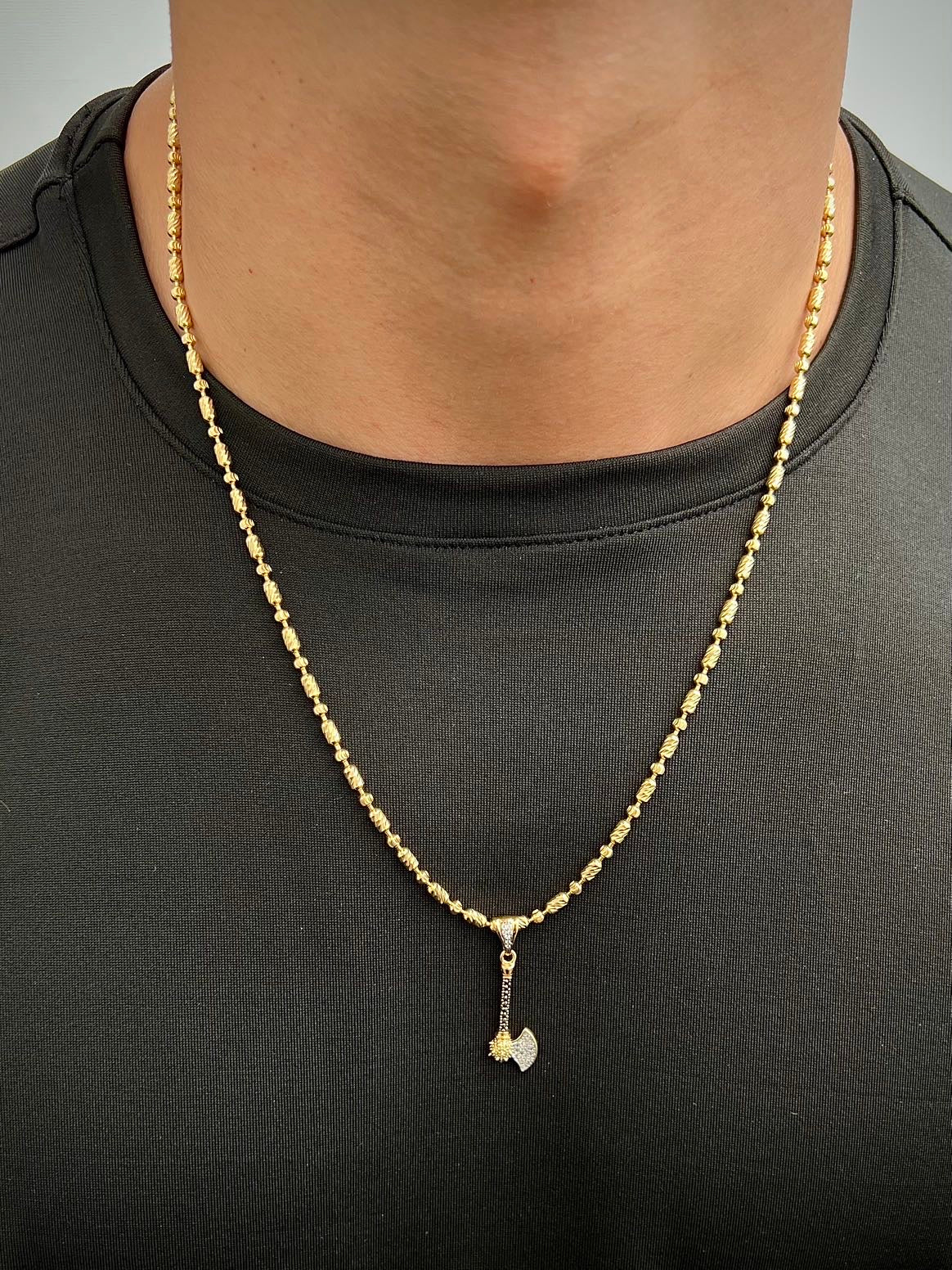 Dije hacha con swarovski blanco y negro 2.1gr / Largo 3.5cm / Oro Amarillo Nac M