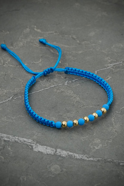 Pulsera en hilo azul con bolas lisas y neoprenos 0.4gr — Oro Amarillo