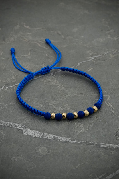 Pulsera en hilo azul rey con con bolas lisas y neoprenos 0.4gr — Oro Amarillo