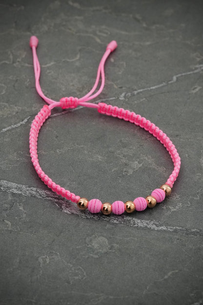 Pulsera en hilo rosado con bolas lisas y neoprenos 0.4gr / Oro Rosado (Joya) M