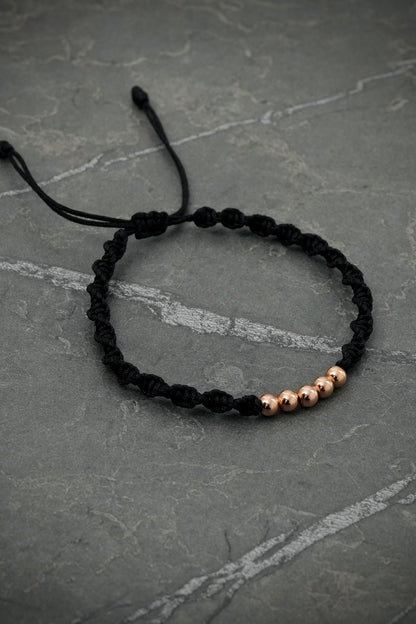 Pulsera en hilo negro con bolas lisas 0.4gr / Oro Rosado (Joya) M