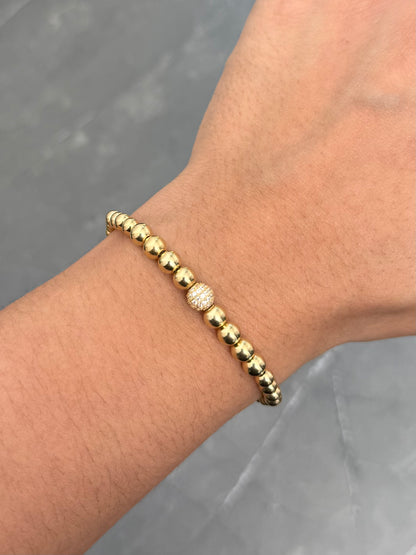 Pulsera en Hilo Beige con Bolas Lisas y Bola de Fuego 3gr — Oro Amarillo
