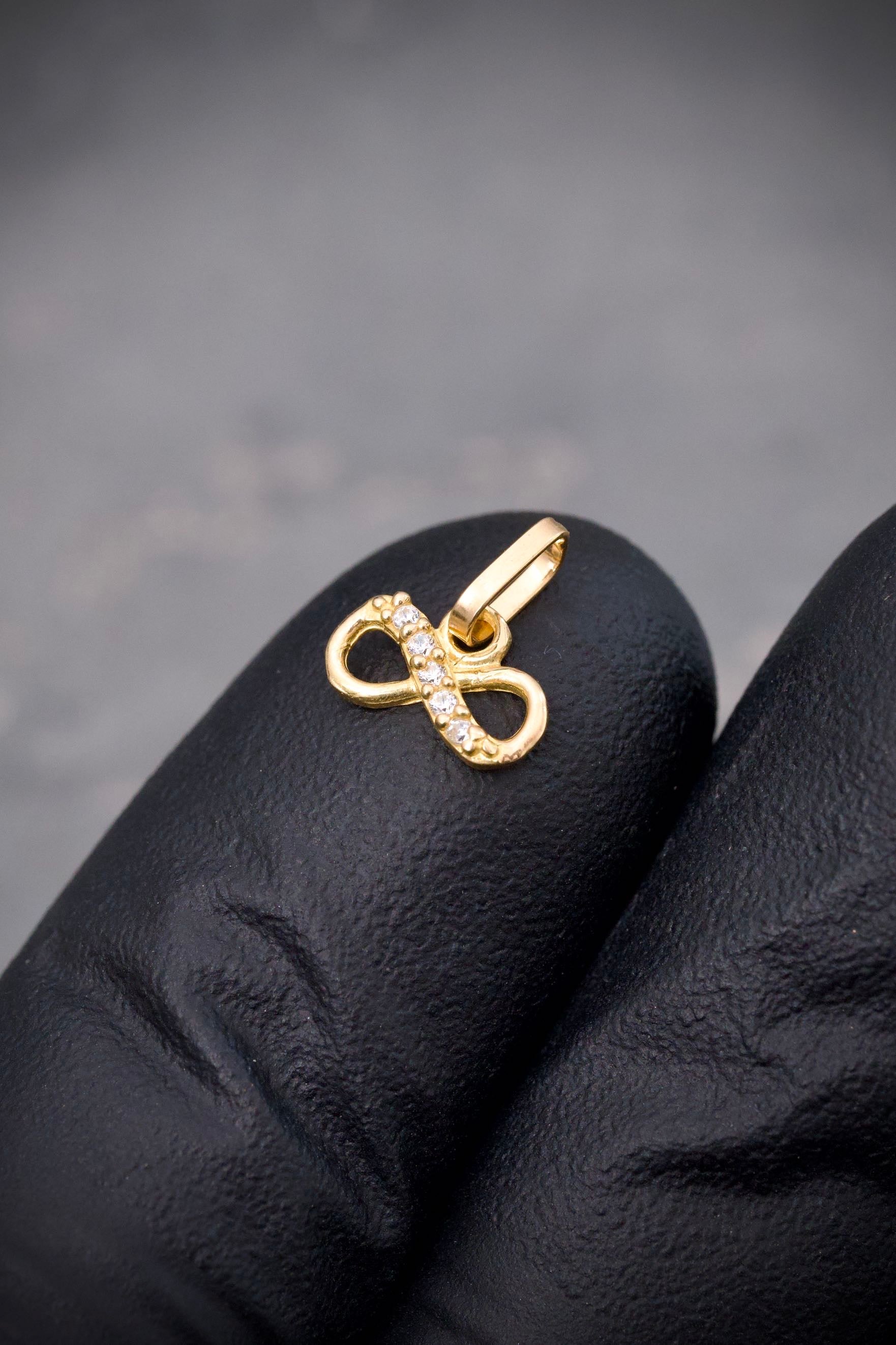 Dije infinito con swarovski blanco 0.3gr / Largo 0.9cm / Oro Amarillo Nac B