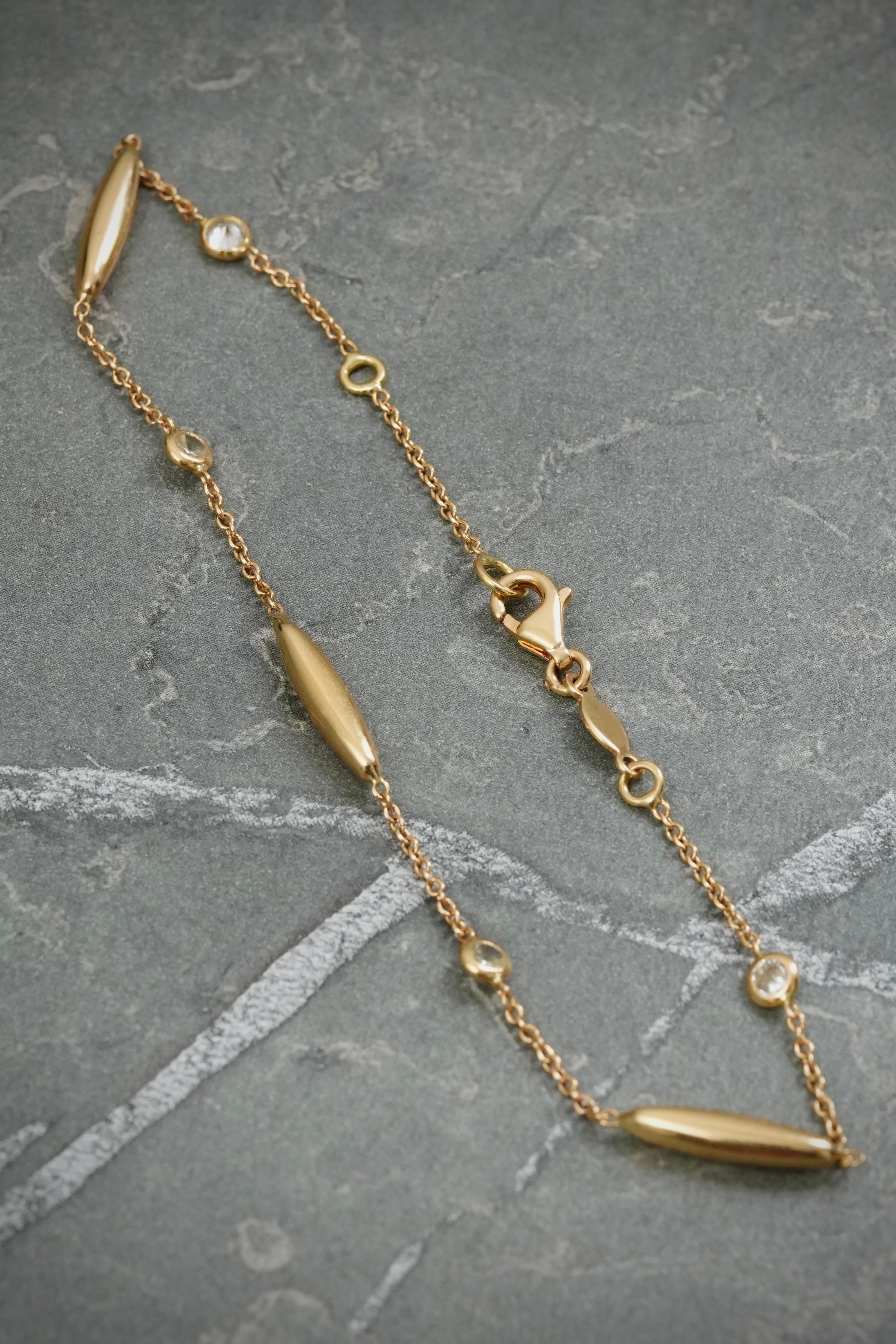 Pulso tejido rolon con swarovski blanco 2.6gr — Oro Amarillo