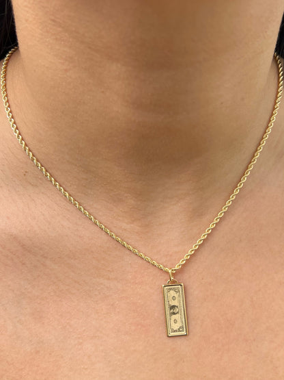 Dije dolar 1.1gr / Largo 3cm — Oro Amarillo
